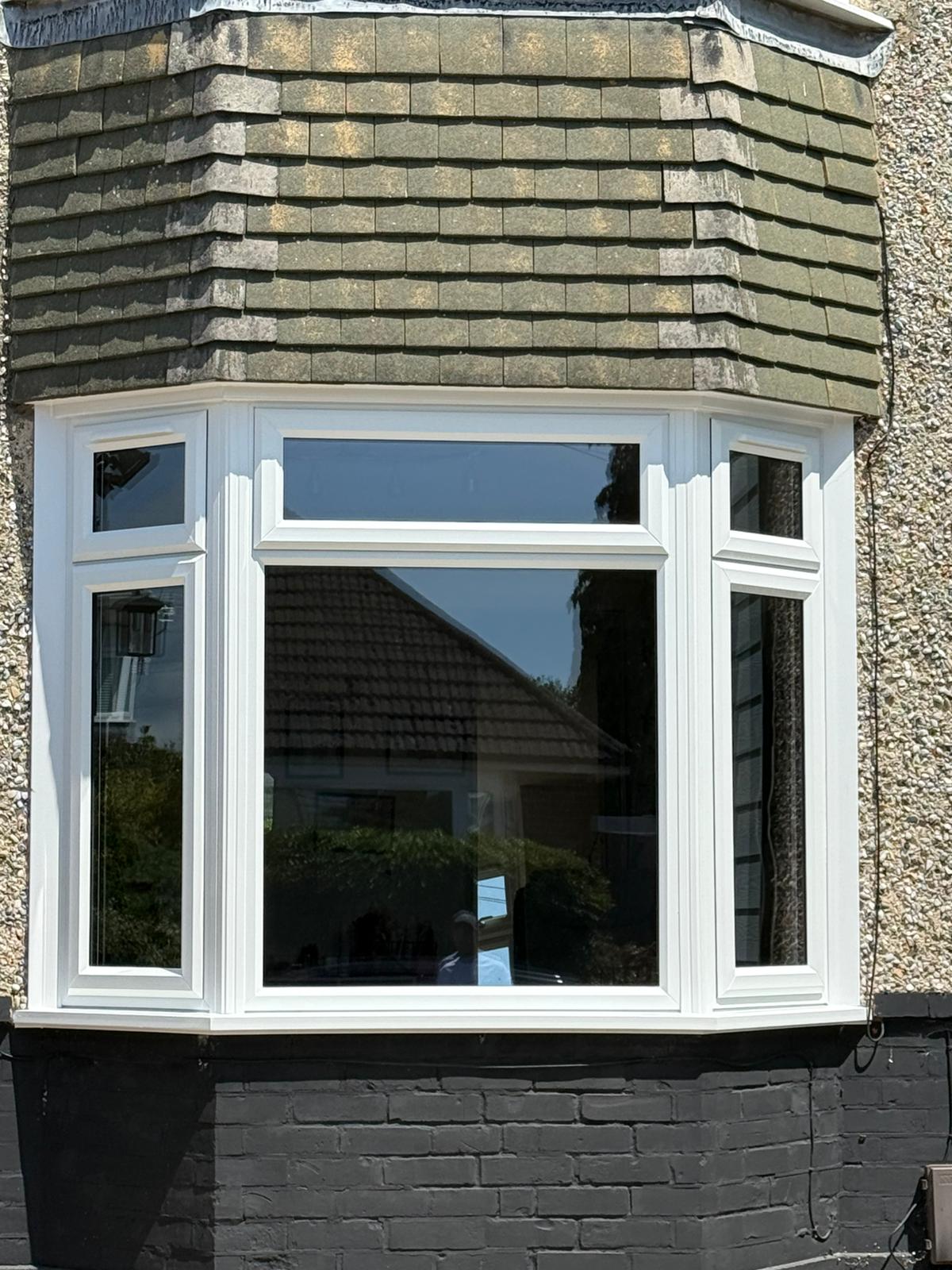 Double-glazed bay window fitted on terraced home exterior, showcasing energy-efficient design by RILU