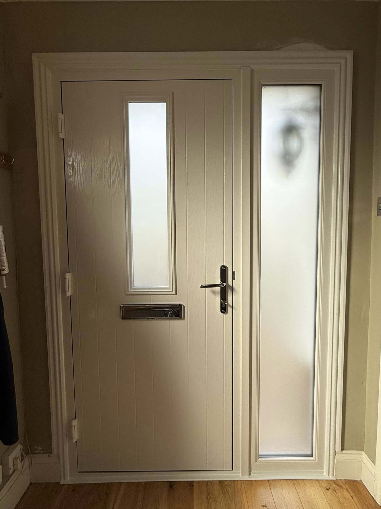 Interior view of a front door with frosted glass, blending privacy and style.