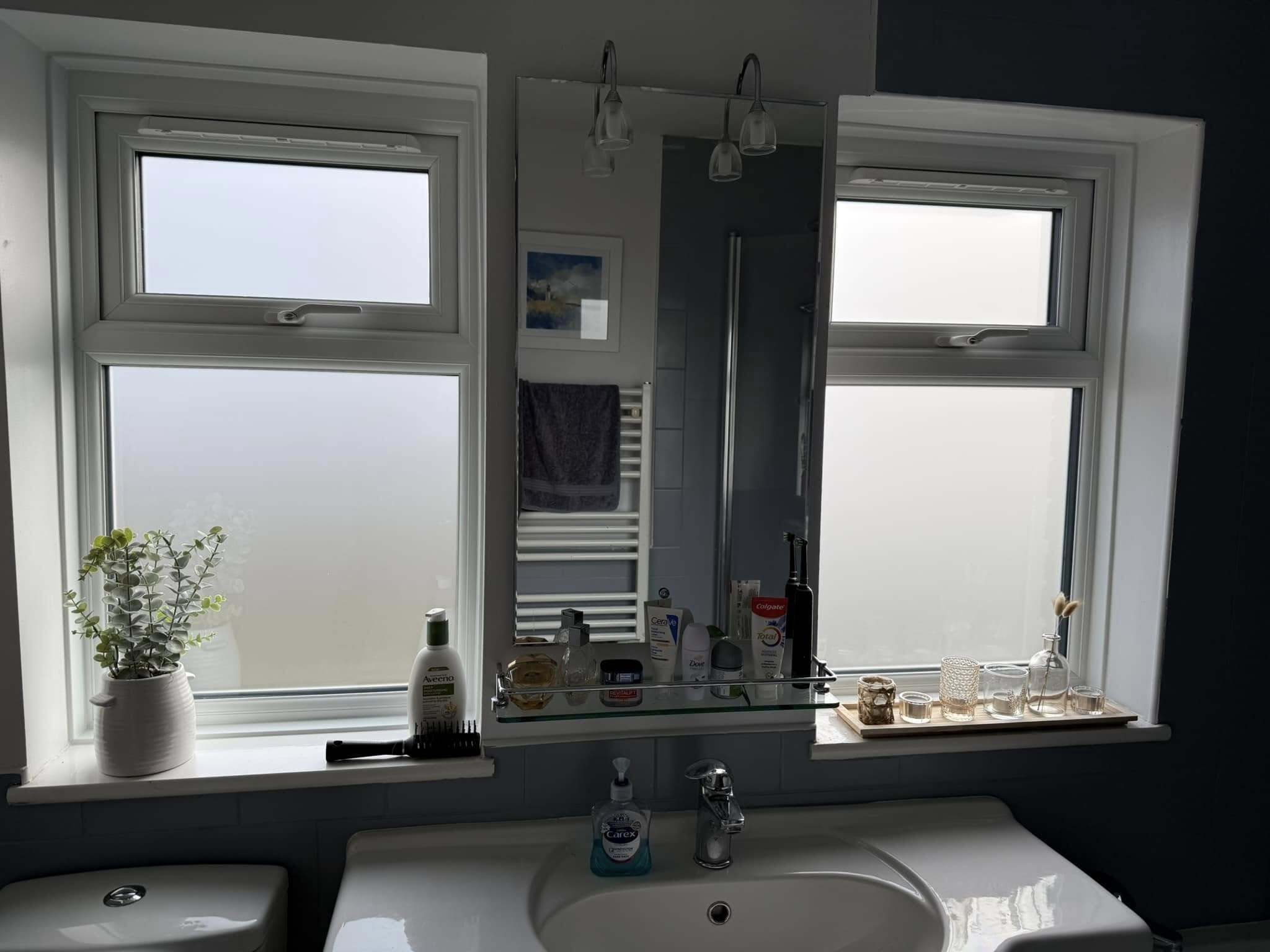 Obscure glass in a modern kitchen window, allowing natural light while maintaining privacy.