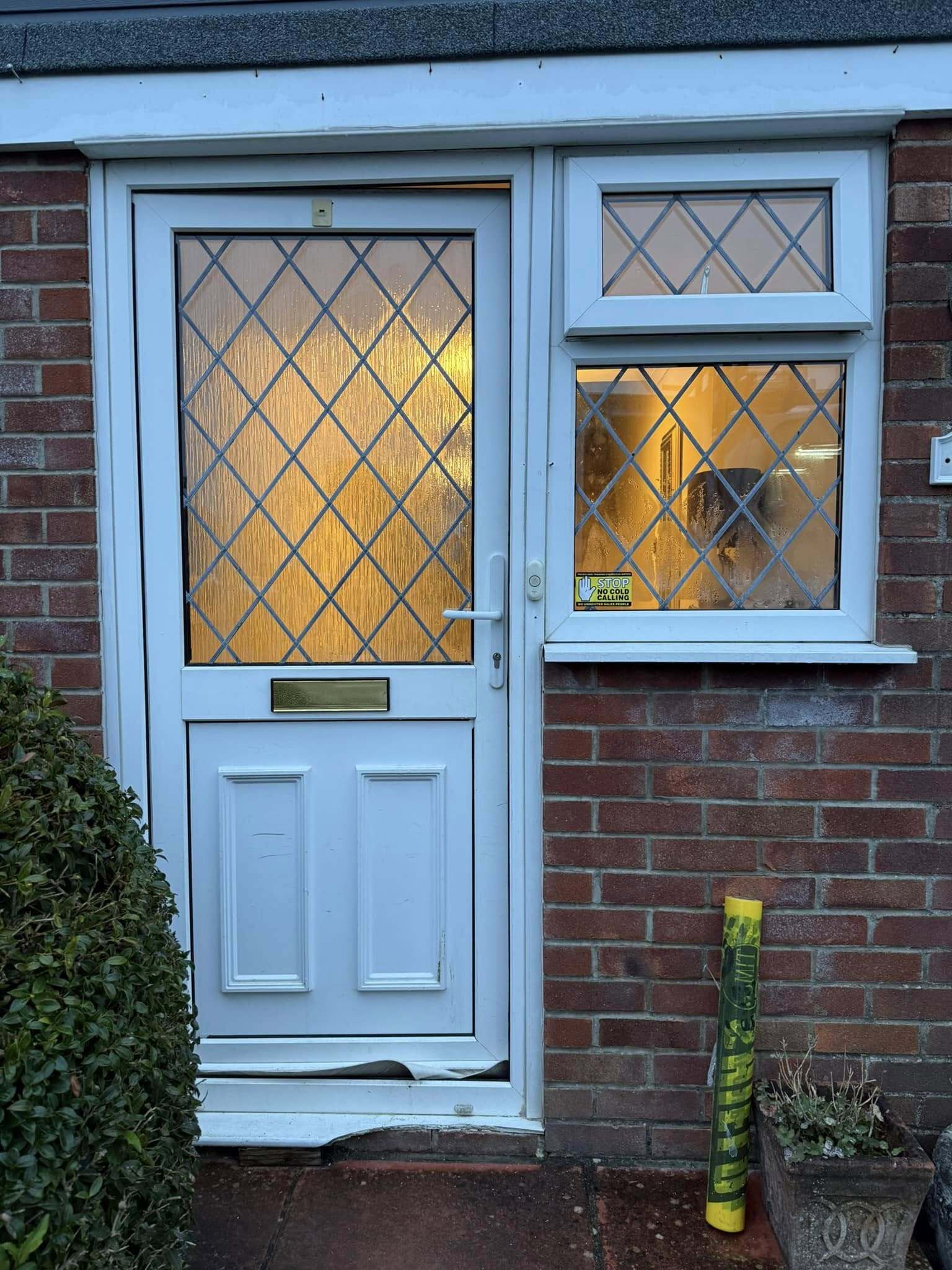 White front door featuring obscure glass, offering a clean, classic look with added privacy.