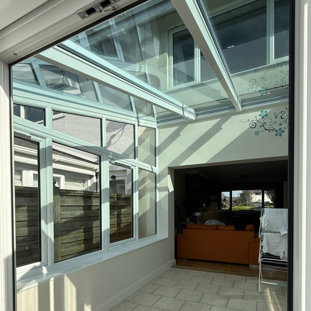 Interior view of a conservatory with a glass roof
