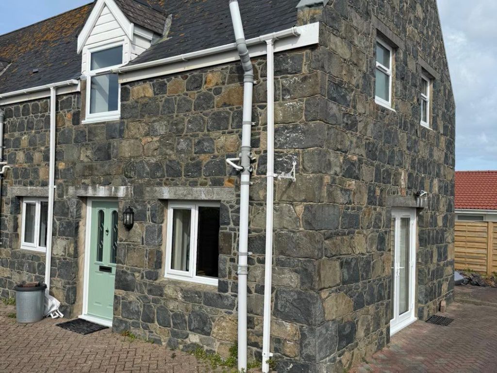 A cottage with heritage windows and doors